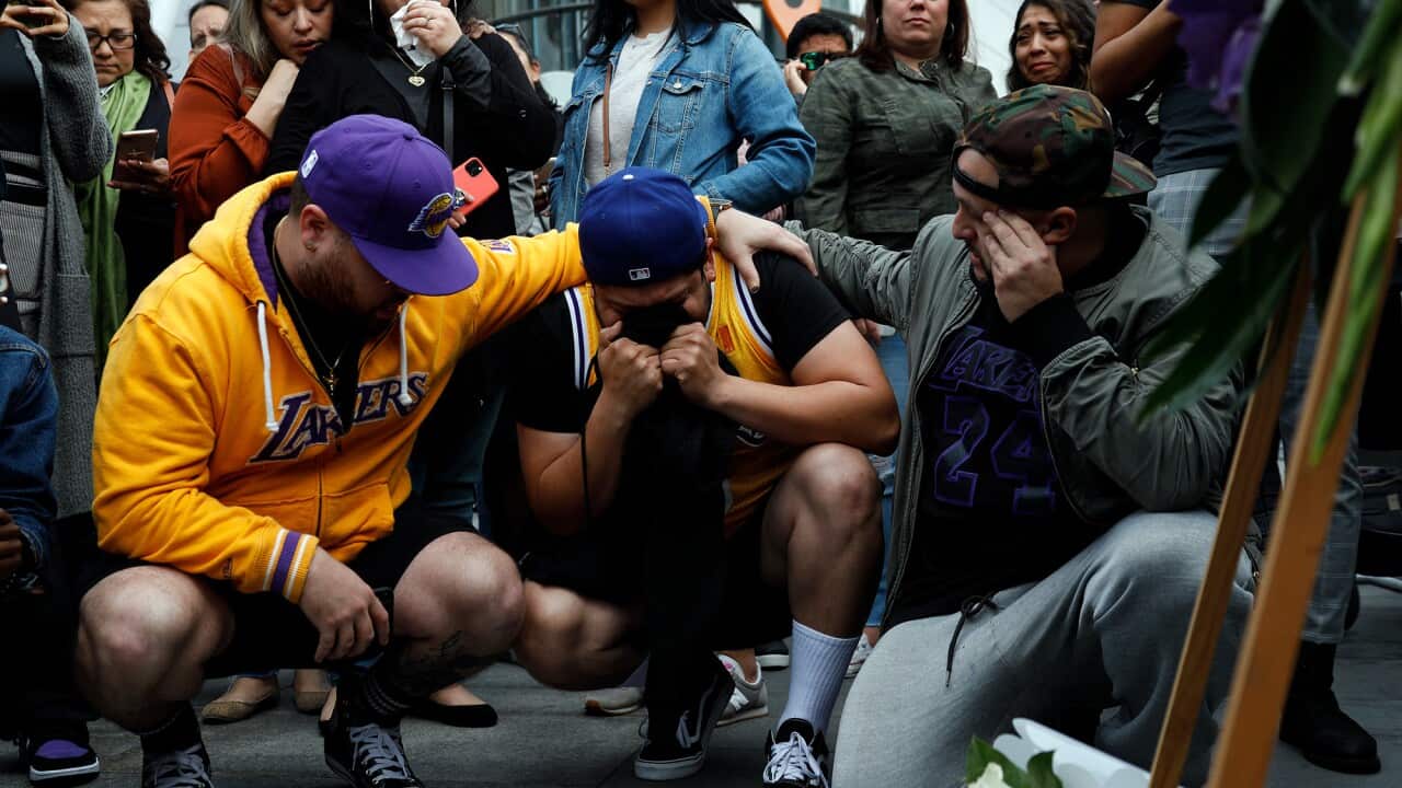 Fans mourn at a memorial for Kobe Bryant, who died in a helicopter crash on Sunday, 26 January.