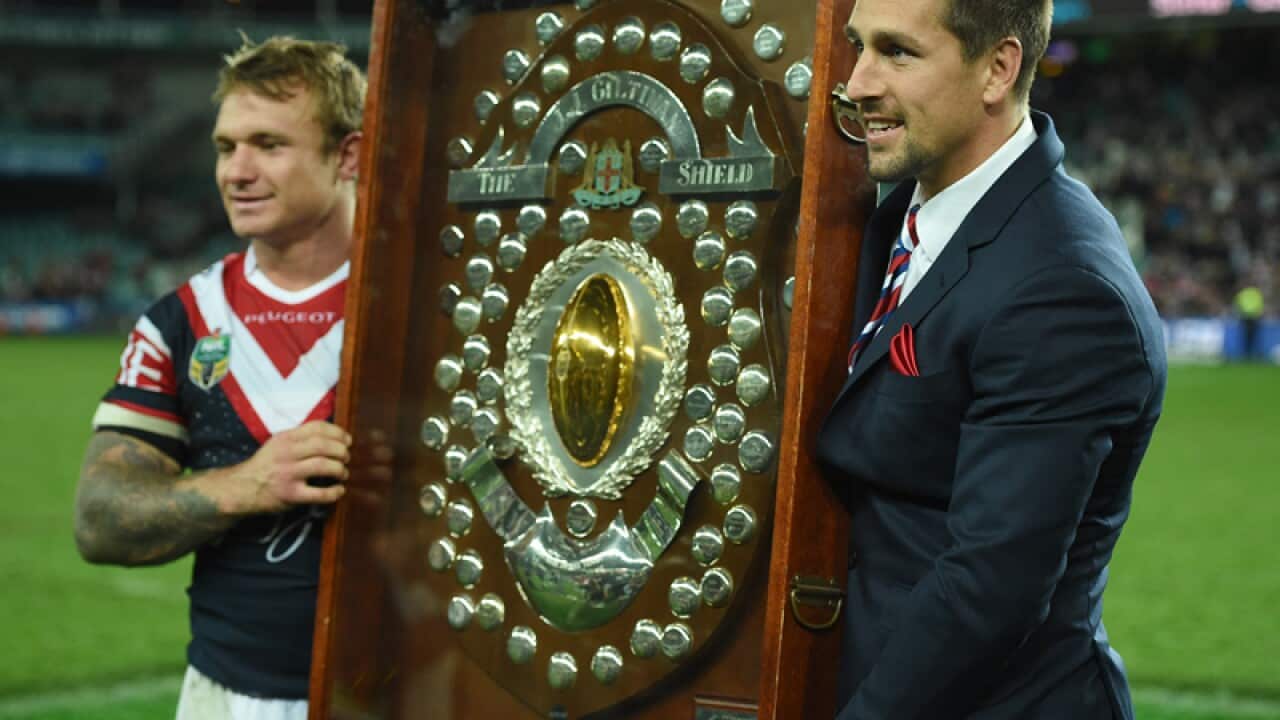 Roosters players hold aloft the J J Giltinan Shield