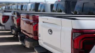 A line of large American-style pickup trucks.