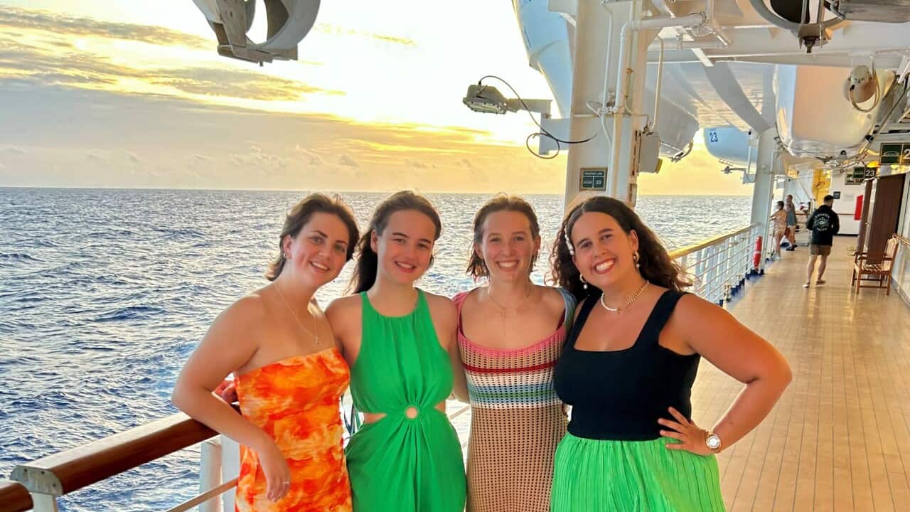 Four young women smiling on a cruise ship