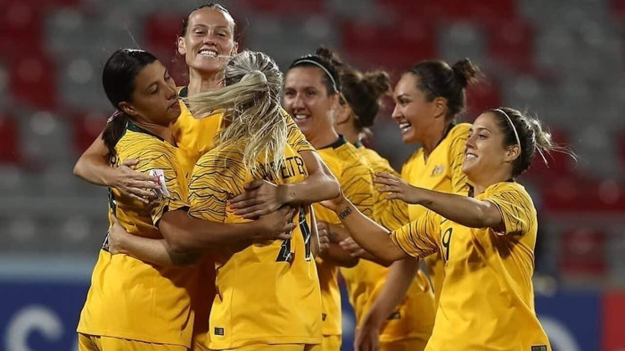 Matildas players celebrate after scraping past Thailand