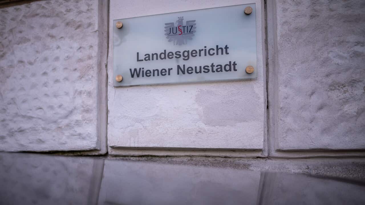 A sign on a building that reads: "Landesgericht Wiener Neustadt".