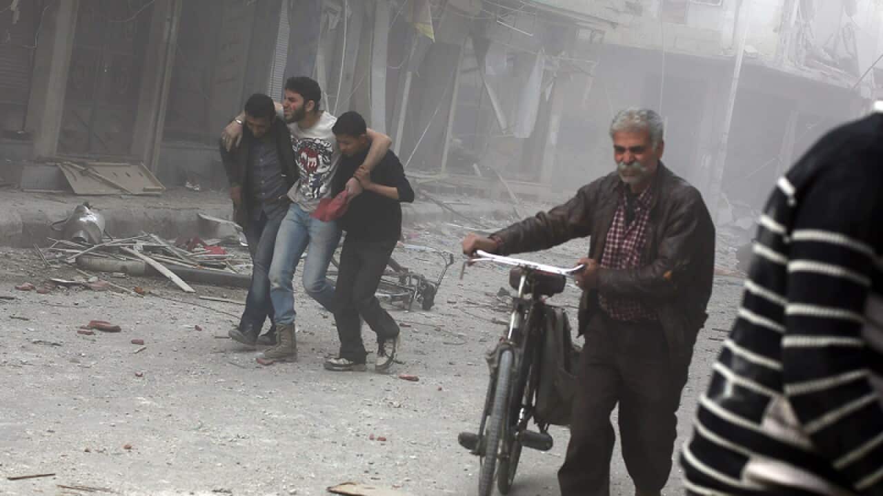 A man is helped away following an alleged air strike