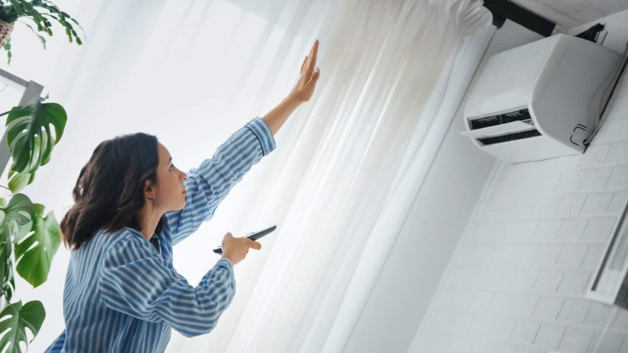 Woman checking aircon