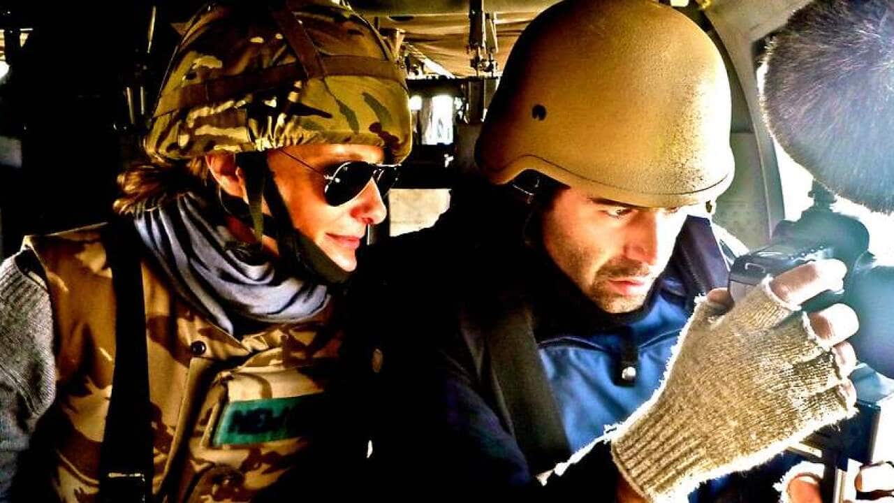 eva orner and abazar khayami on a blackhawk somewhere over kabul.jpg