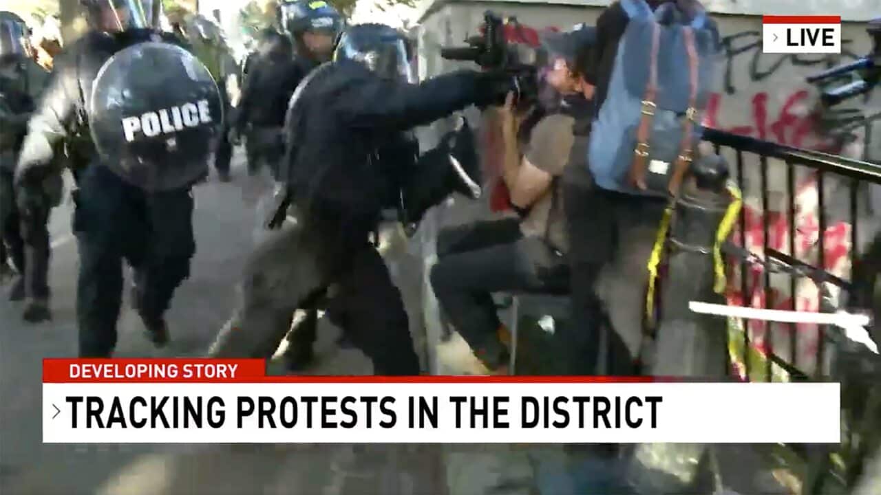 Network Seven cameraman Tim Myers assaulted by police officers while covering protests outside the White House in Washington.
