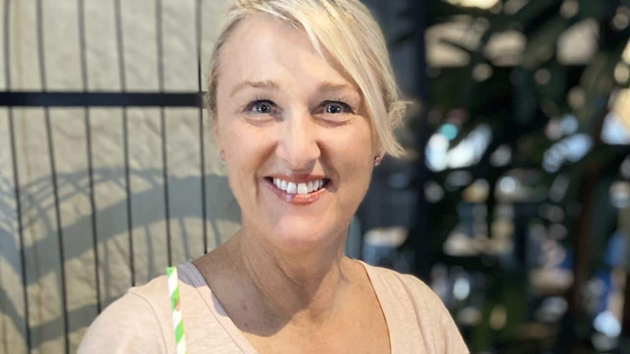 A blonde woman smiling