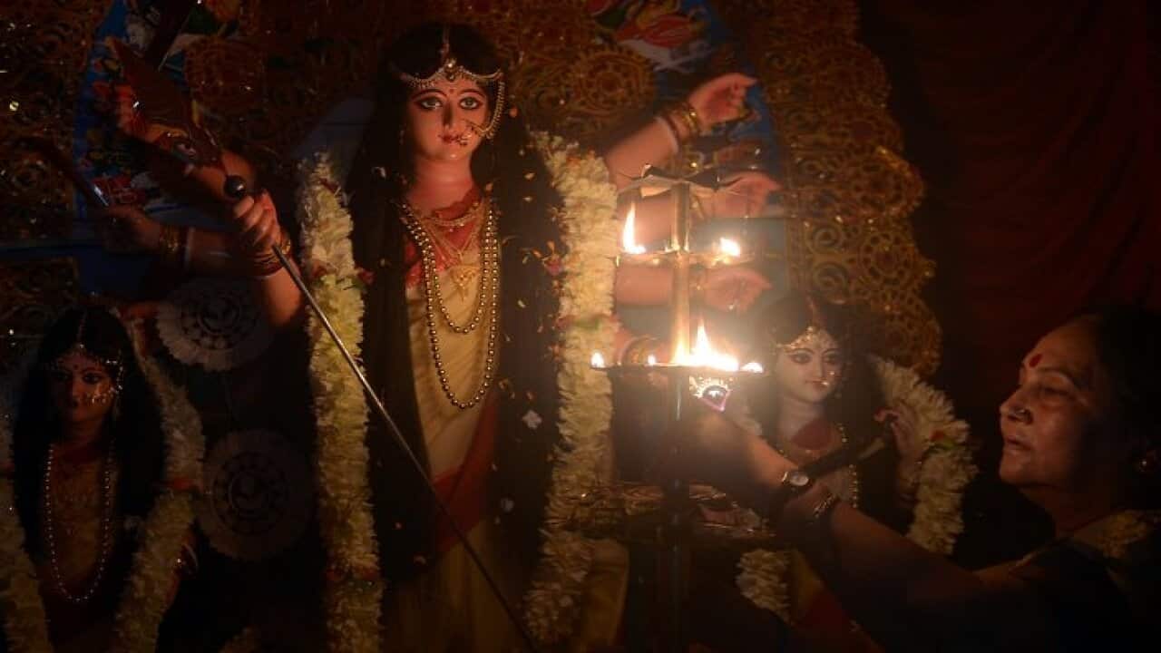 An Indian sex worker performs Aarti