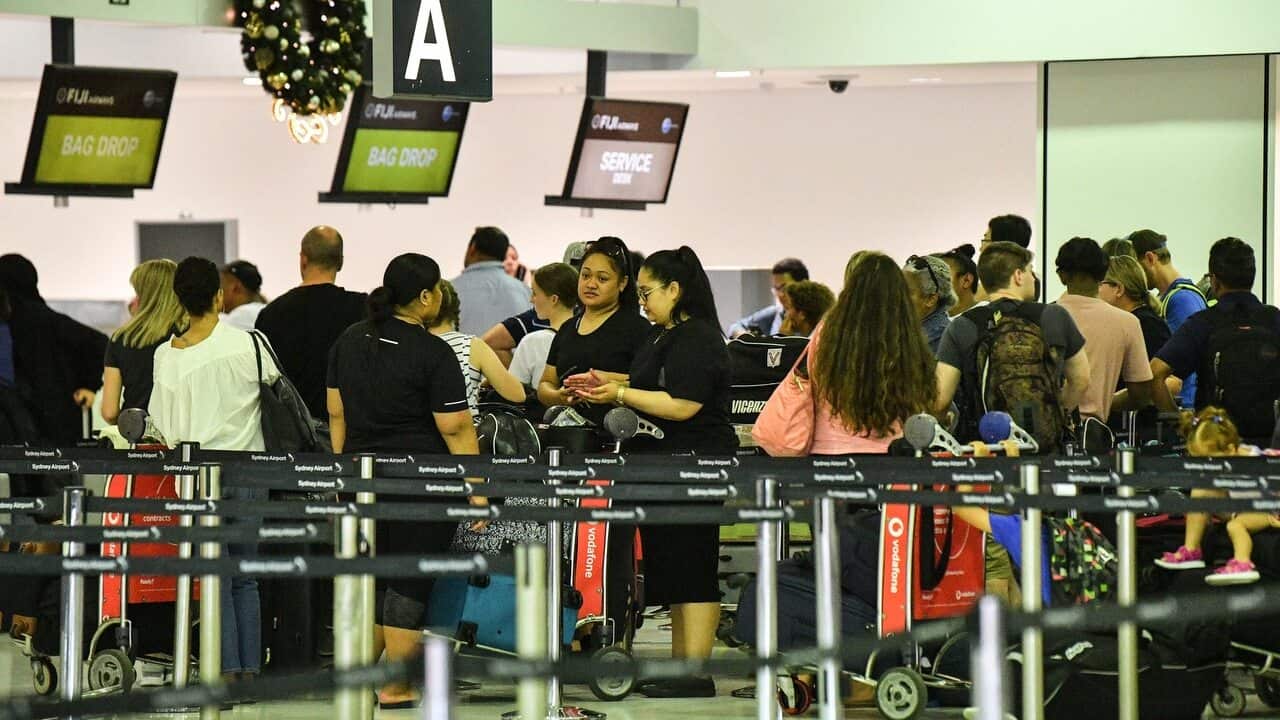 Travellers are seen queueing Overseas Arrivals and Departures at Sydney's International Airport in Sydney on 17/12/18,