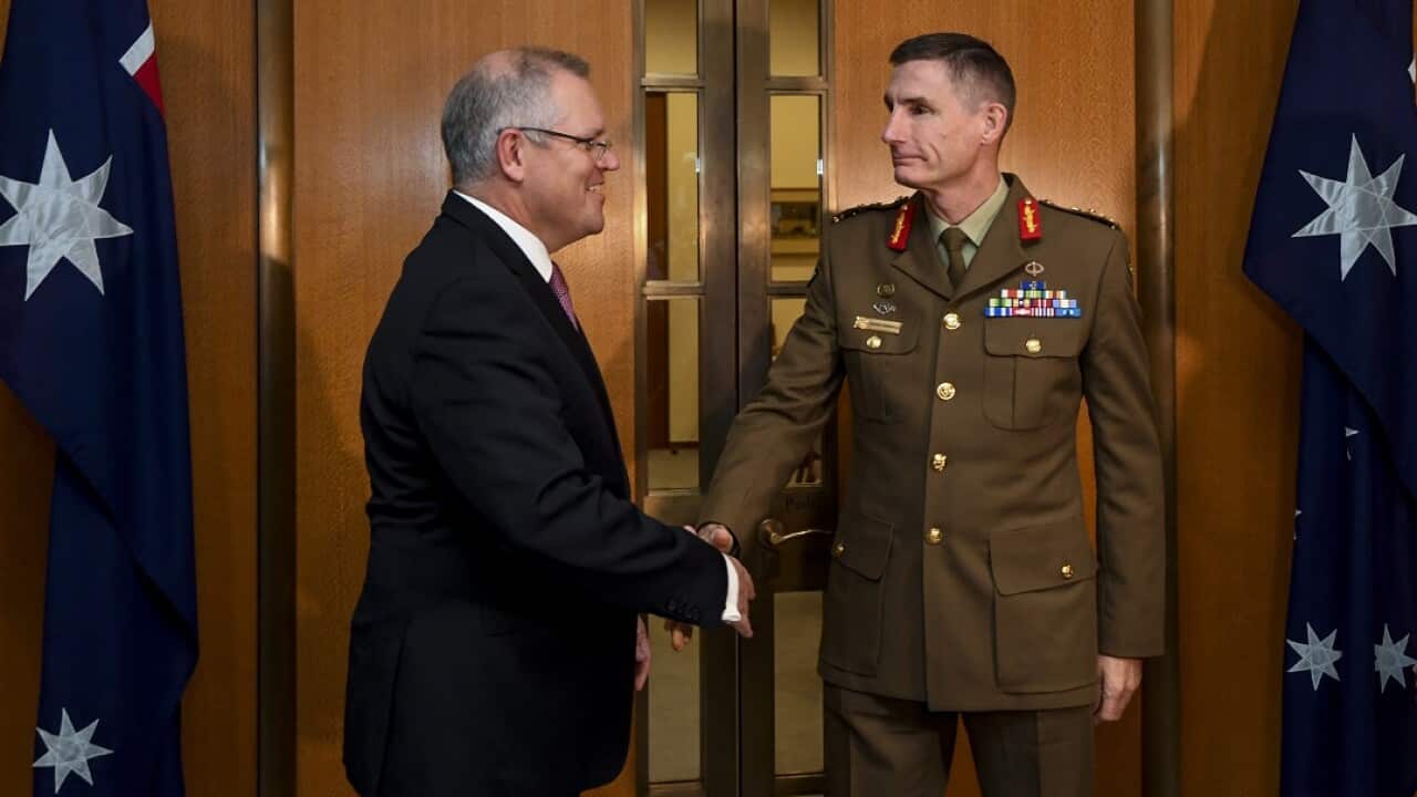 Chief of the Australian Defence Force General, Angus Campbell shakes hands with Australian Prime Minister Scott Morrison.