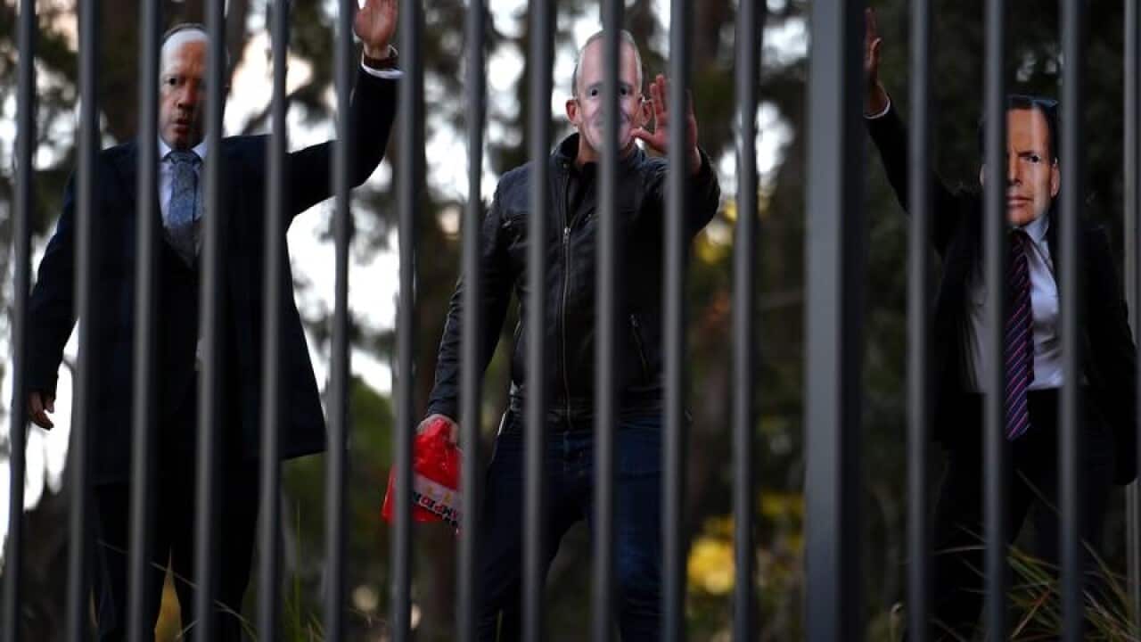 Protesters in Peter Dutton, Malcolm Turnbull and Tony Abbott masks