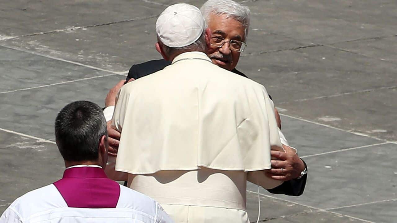 Pope Francis greets Palestinian President Mahmoud Abbas as he leaves St. Peter's Square at the end of a canonisation ceremony on May 17, 2015