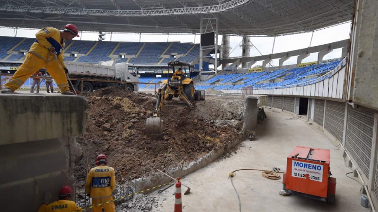 Construction workers inside the Olympic Stadium in Rio de Janeiro