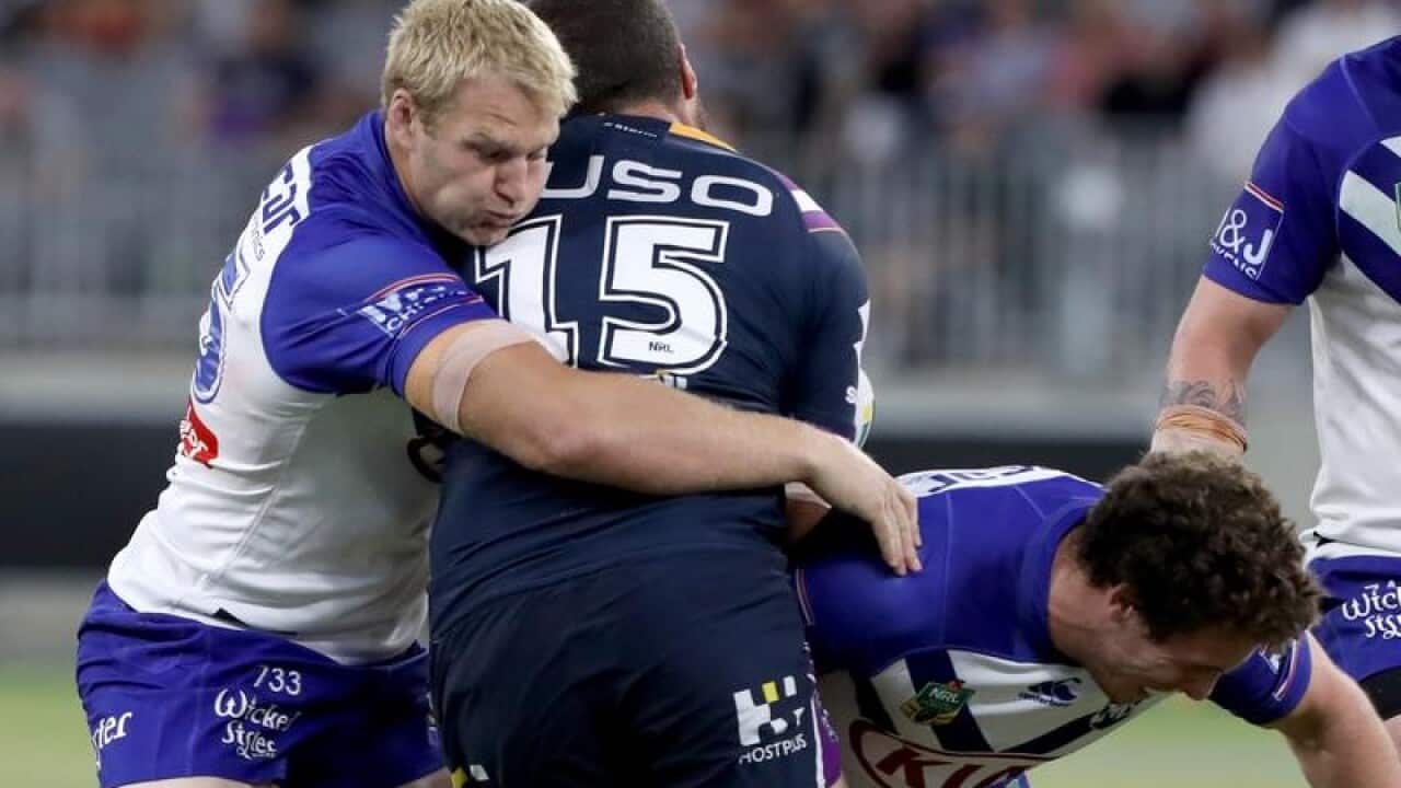 Bulldogs prop Aiden Tolman (L) tackles Kenneath Bromwich of the Storm