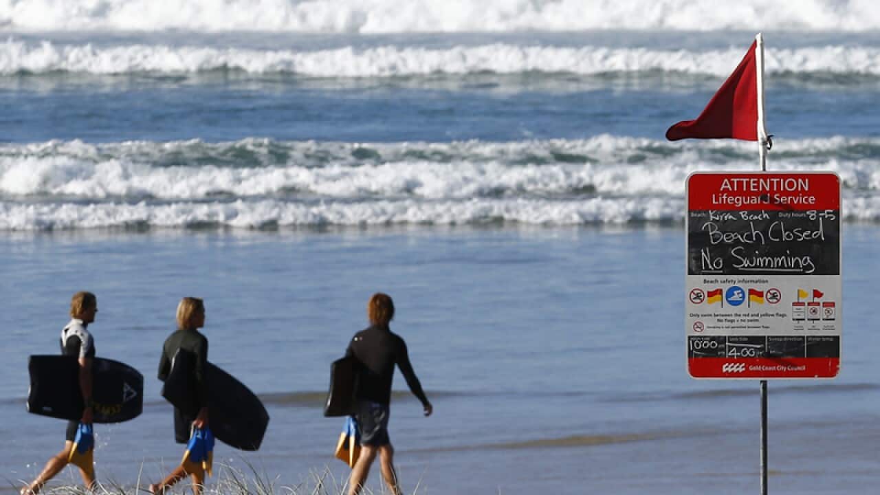A closed beach sign is seen at Kirra beach on the Gold Coast