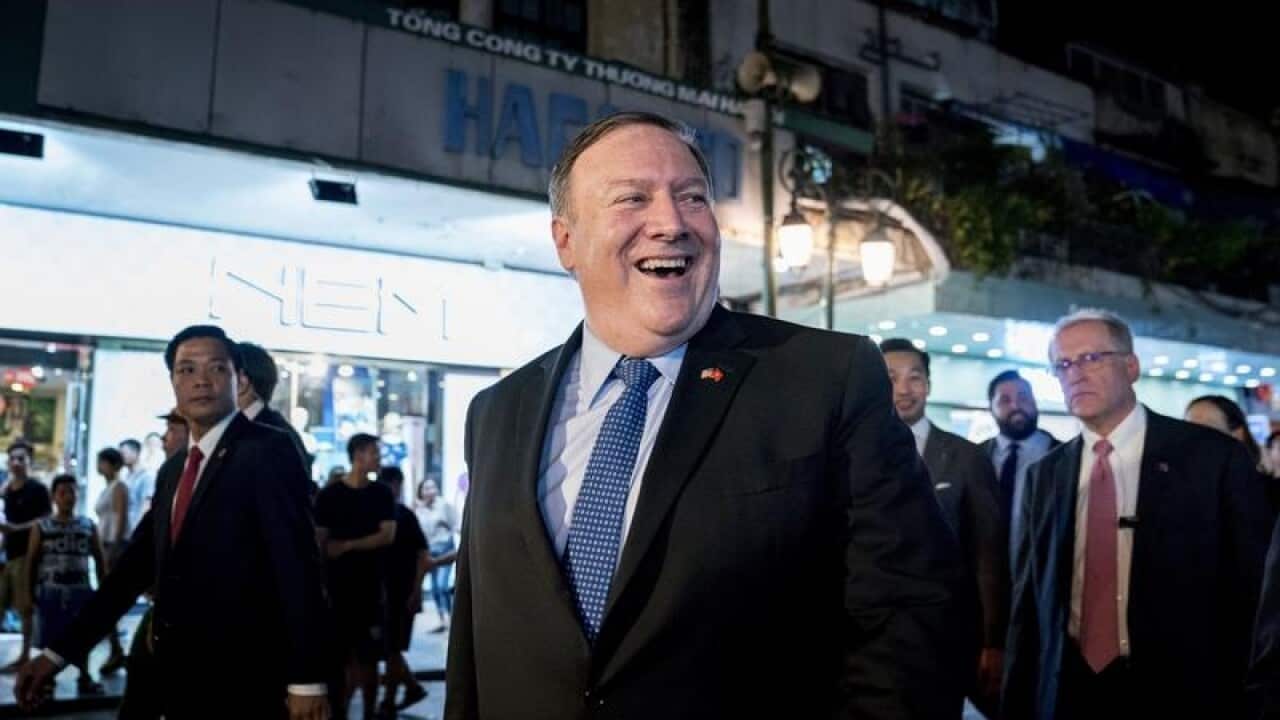 Mike Pompeo walks through the streets of Hanoi