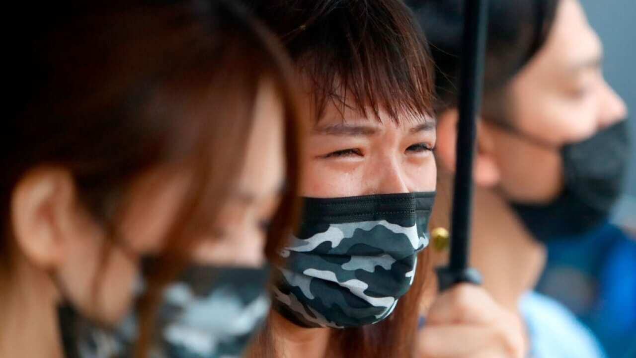 Relatives of the deceased cry during a memorial ceremony.