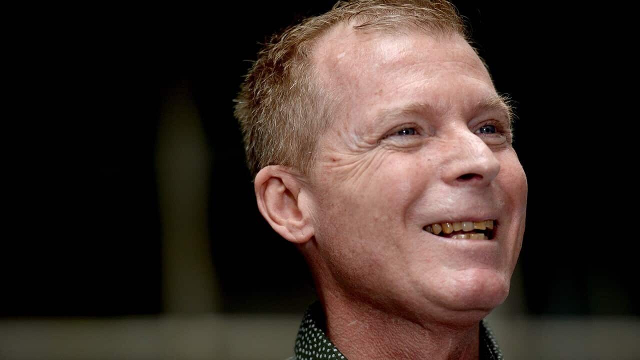 Australian academic Timothy Weeks speaks to the press on Sunday.