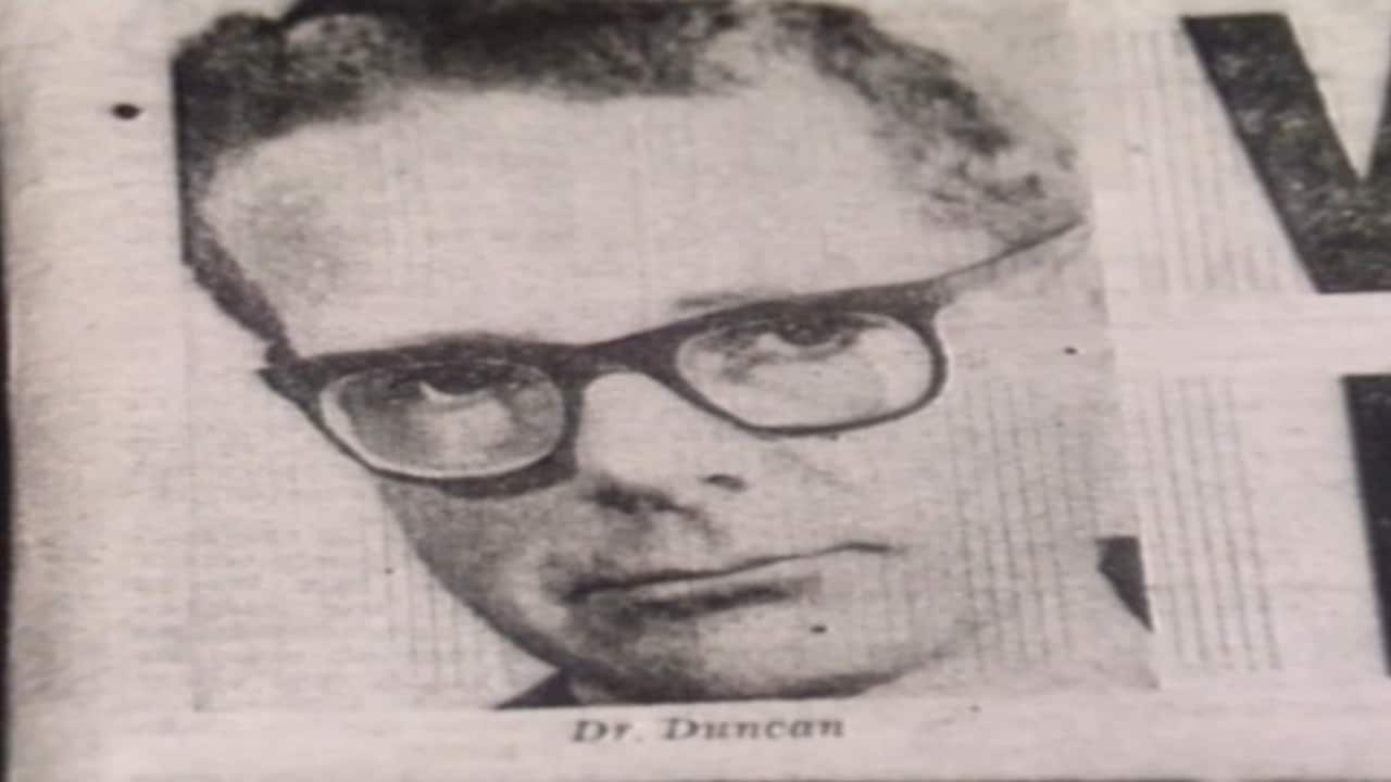 A black and white newspaper clipping of a man wearing thick glasses
