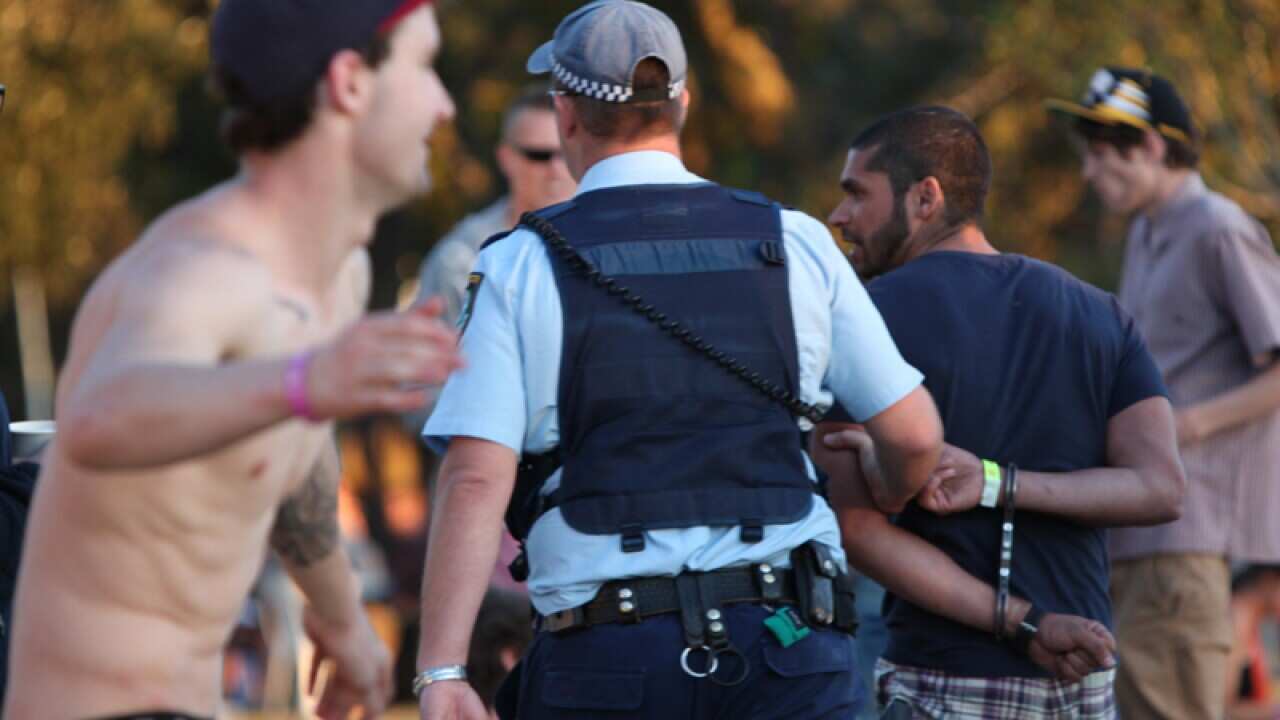 A young man is arrested at a music festival