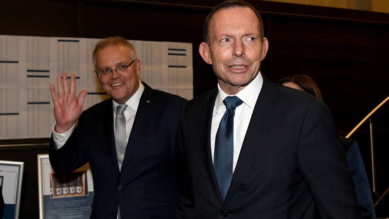 Australian Prime Minister Scott Morrison and former Prime Minister Tony Abbott arrive for the tribute dinner.