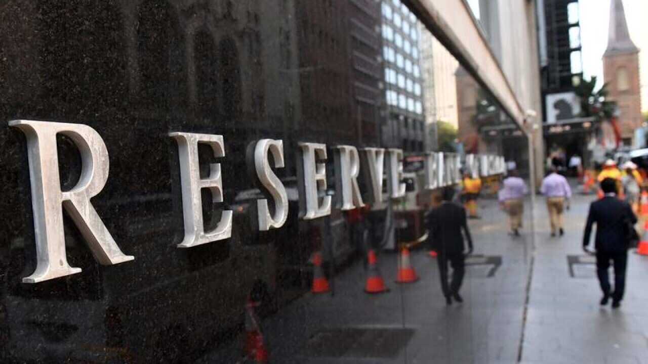 A pedestrian walks past the Reserve Bank of Australia