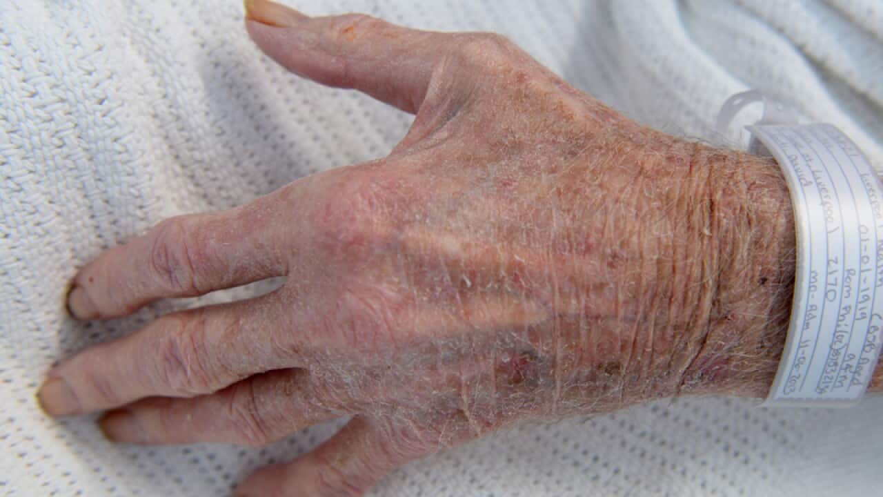 An elderly patient's hand in a hospital