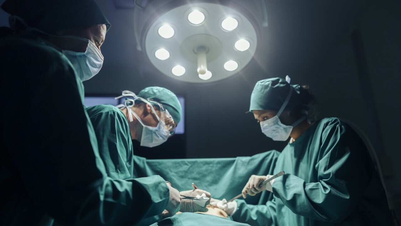 Teamwork and Cooperation Three Surgeons performing operating on a patient in the hospital's operating room