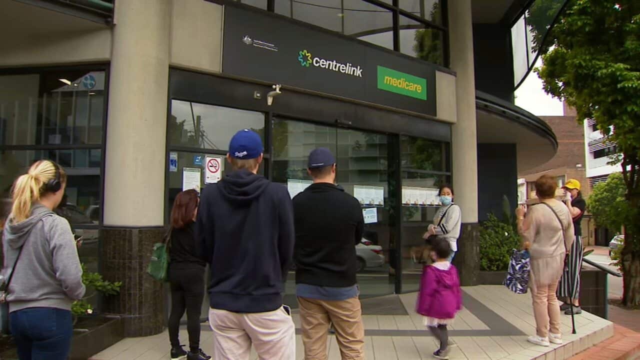 People waiting outside a CentreLink office