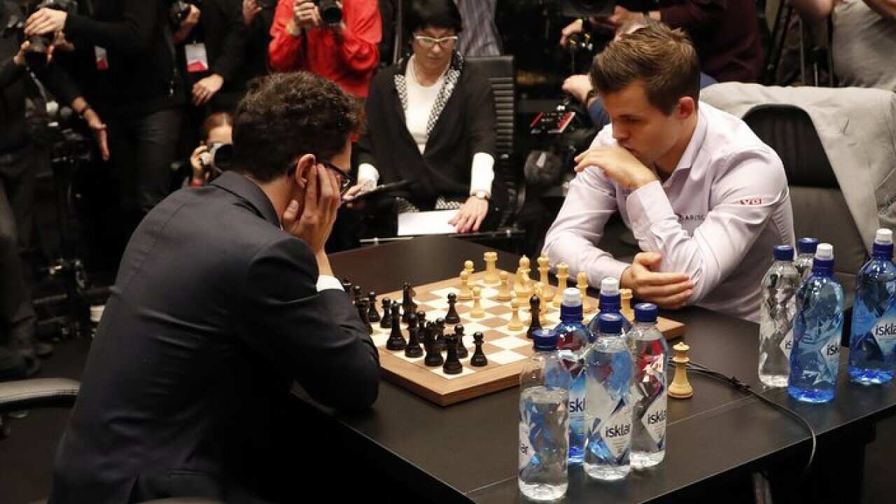 Reigning chess world champion, Norway's Magnus Carlsen, right, and Italian-American Fabiano Caruana concentrate at the final day of the World chess Championship in London, Wednesday, Nov. 28, 2018.(AP Photo/Frank Augstein)