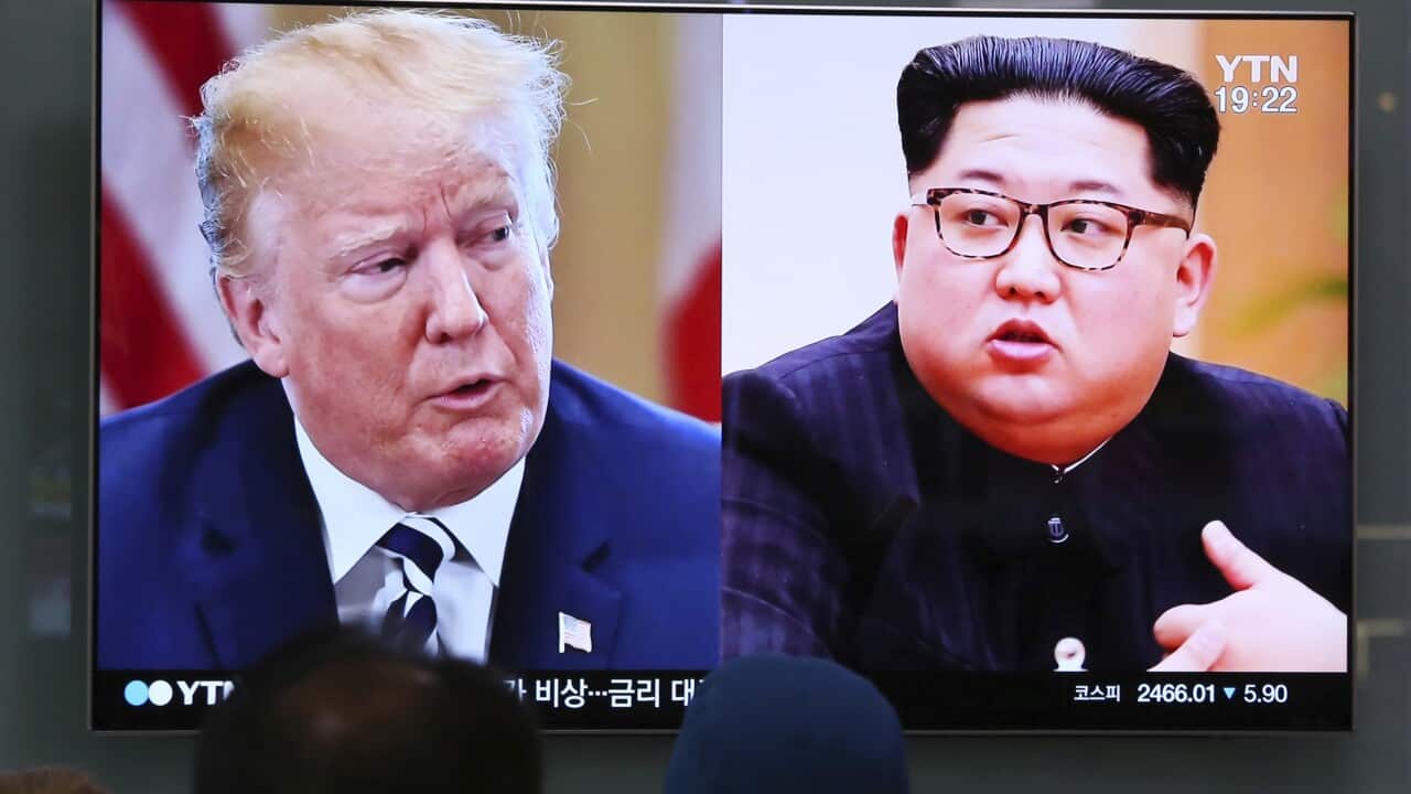 File photo of people watching a TV screen showing footage of US President Donald Trump, left, and North Korean leader Kim Jong-un