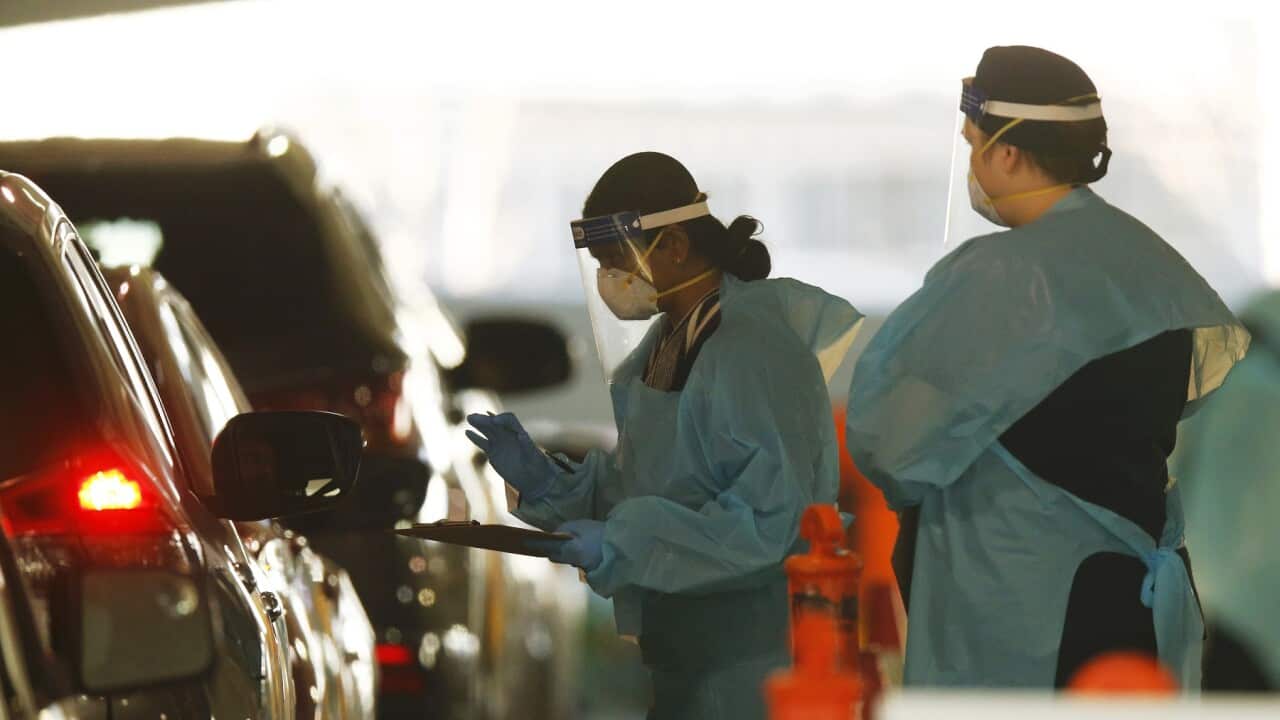 Healthcare workers conduct COVID-19 testing