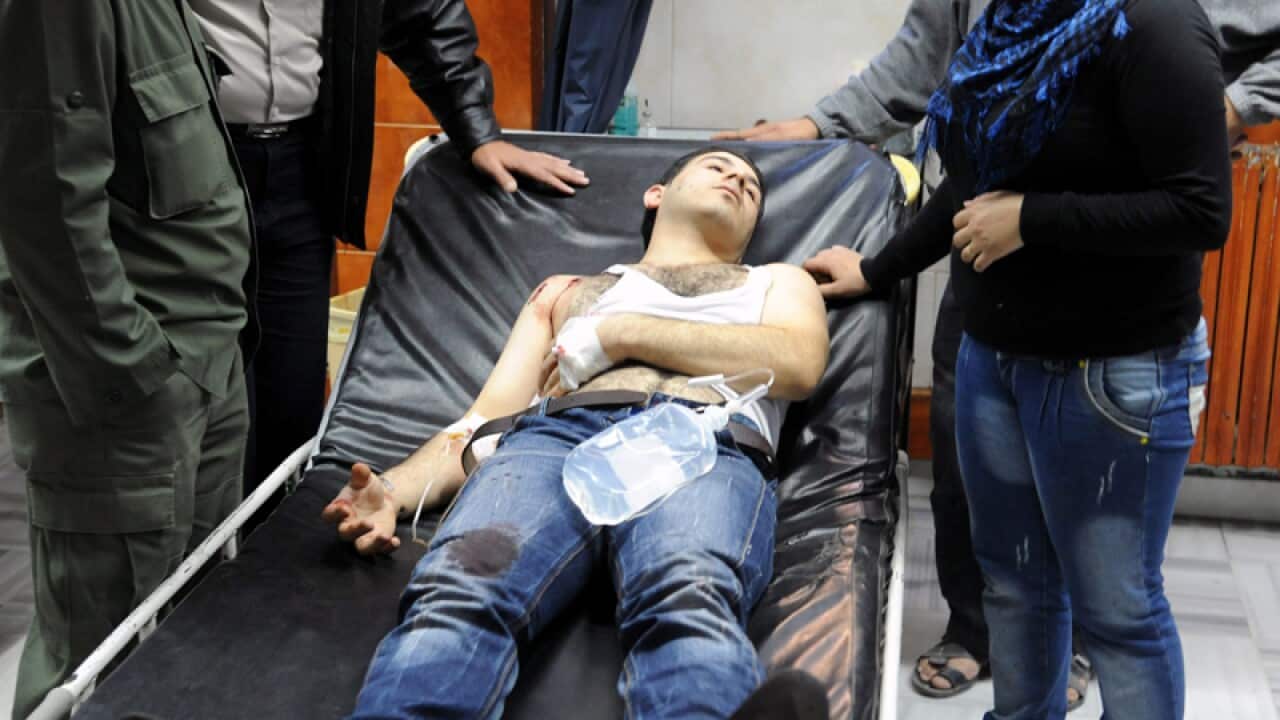 Syrians, wounded in an attack outside a historic Mosque in Damascus