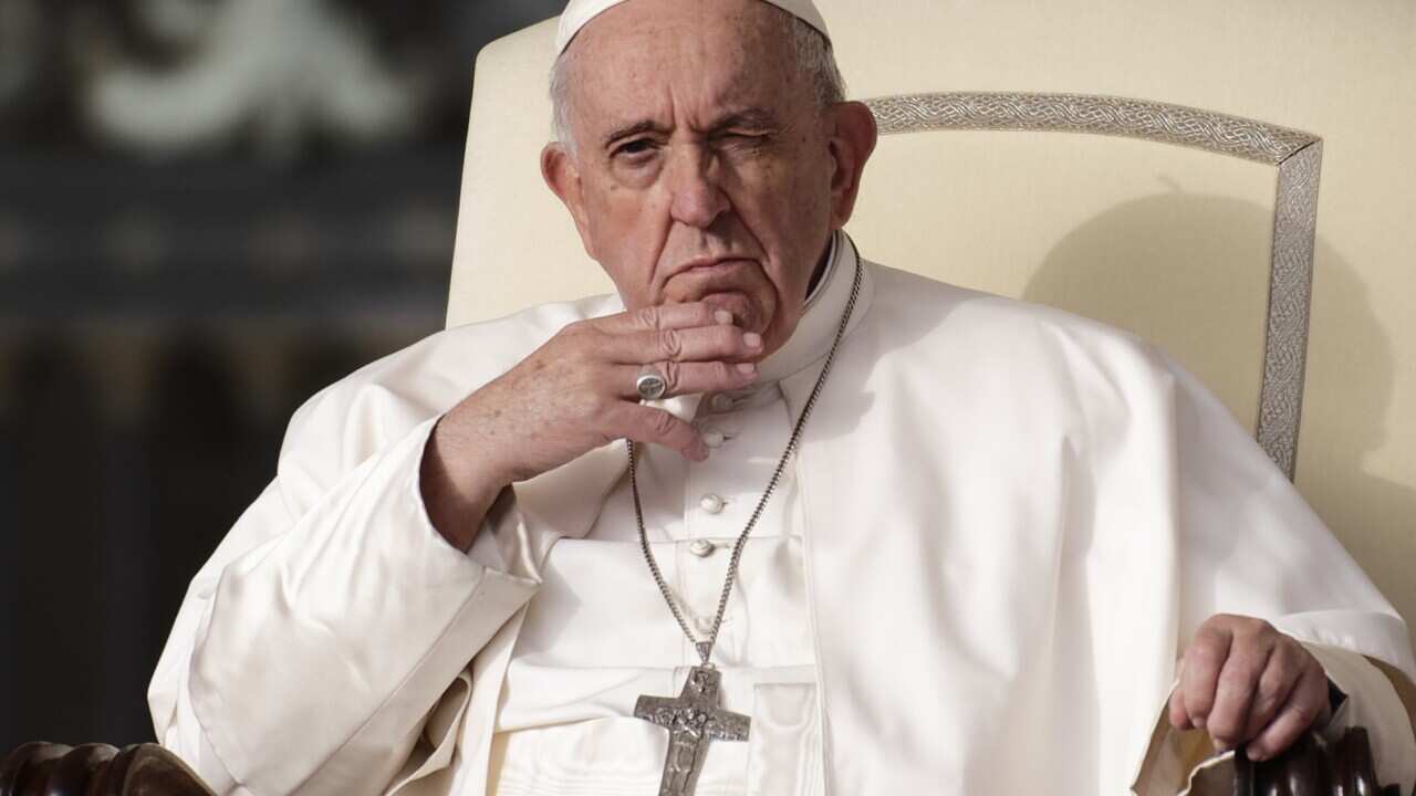 Popre Francis sitting in a chair.