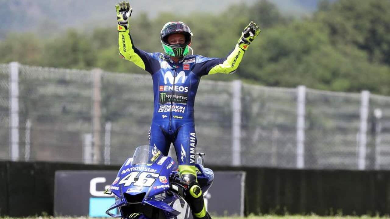 Italian MotoGP rider Valentino Rossi of the Movistar Yamaha MotoGP team celebrates after taking the third place in the Motorcycling Grand Prix of Italy at the Mugello circuit.