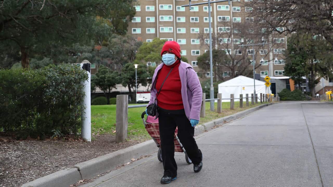 A woman leaves the Albert Street public housing tower in North Melbourne
