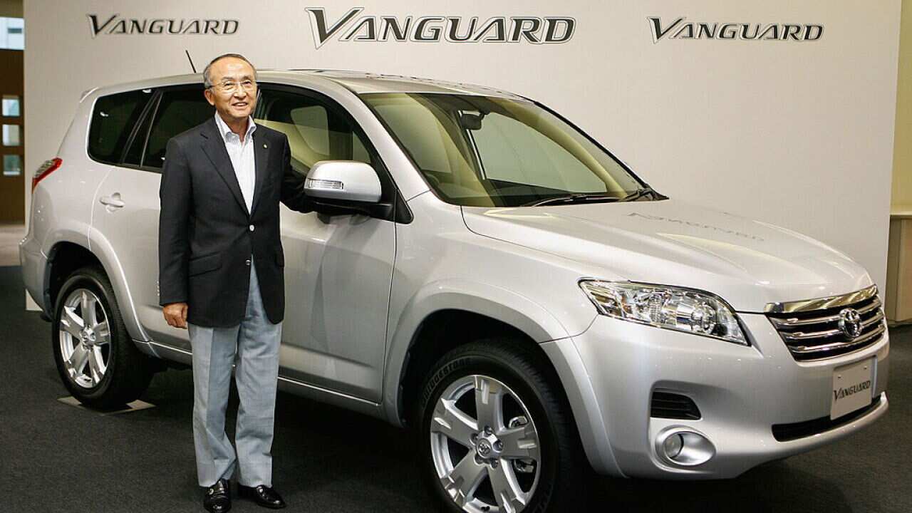 Katsuaki Watanabe, from Toyota, standing next to a Vanguard model, which today was recalled.