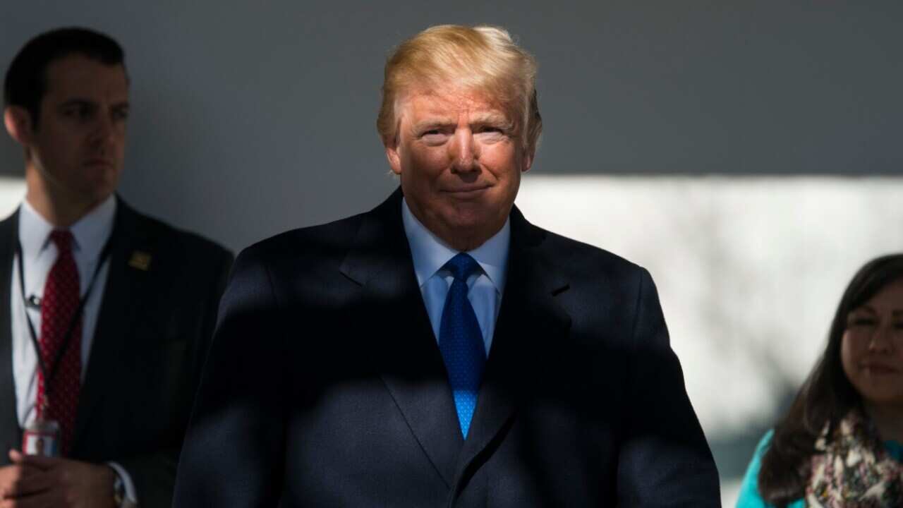 File: US President Donald J. Trump (C)