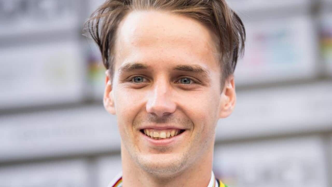 Brisbane's Logan Martin holding a medal