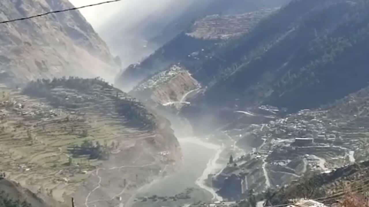 This frame grab from video provided by KK Productions shows a massive flood of water, mud and debris flowing at Chamoli.