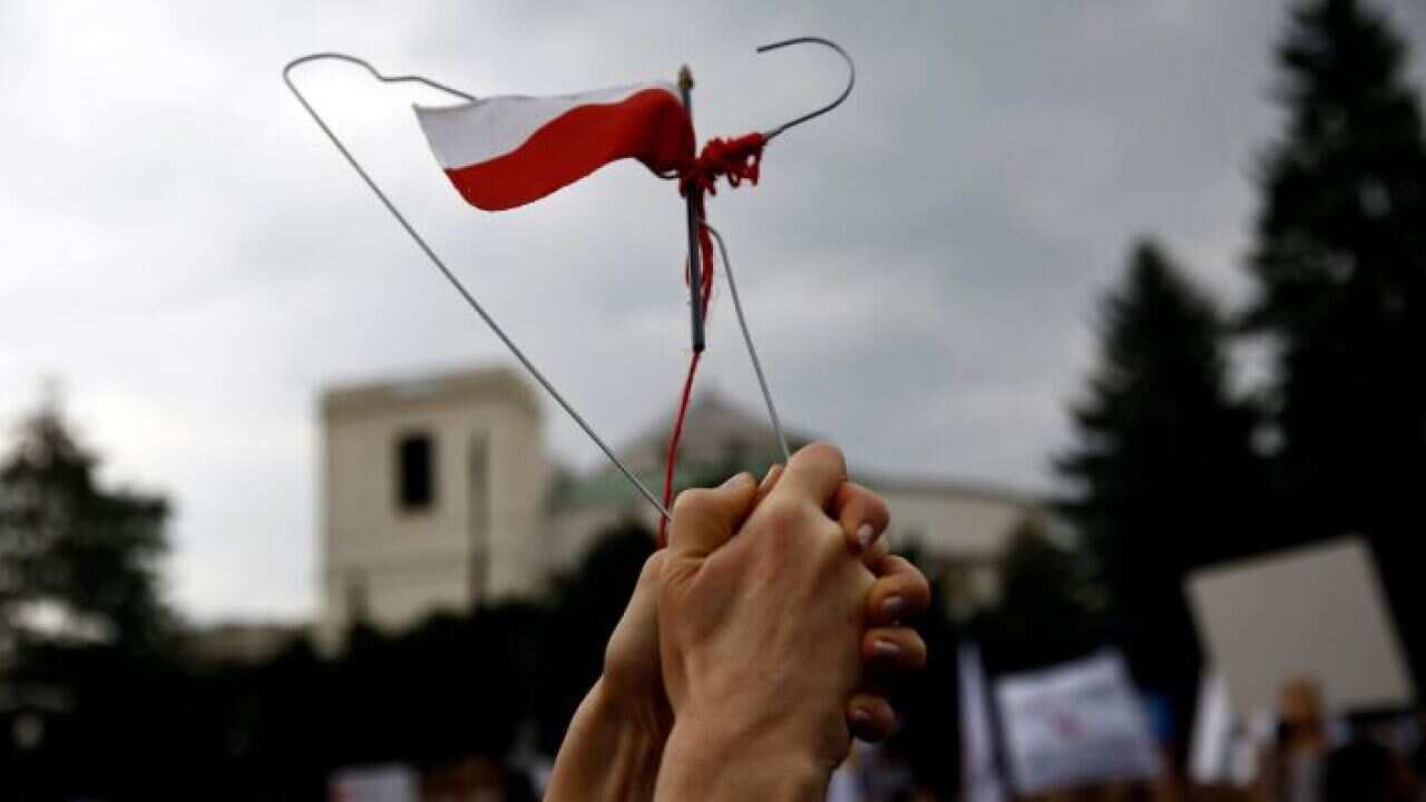 A coat hanger held up as a symbol of protest in Poland.