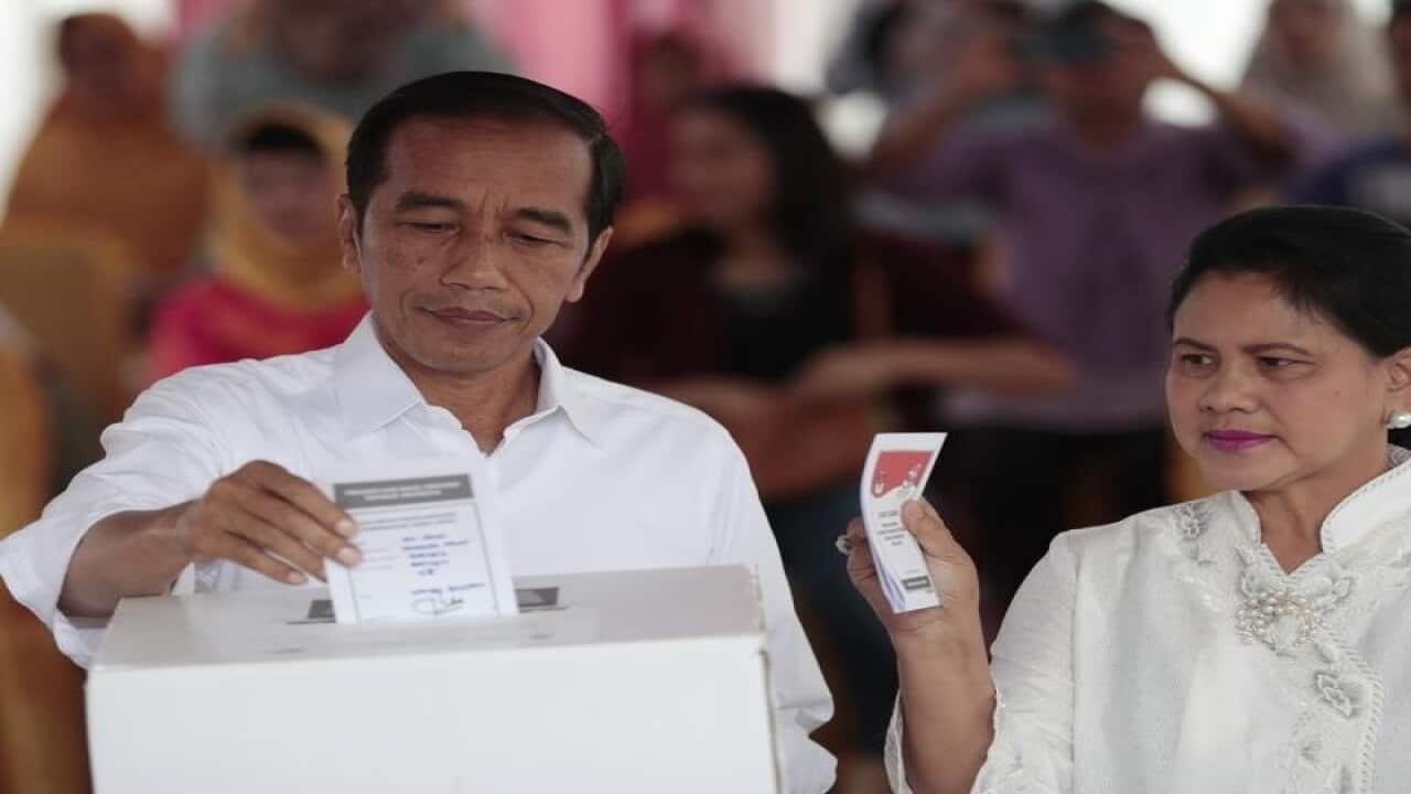 Indonesian President Joko "Jokowi" Widodo and his wife Iriana vote.