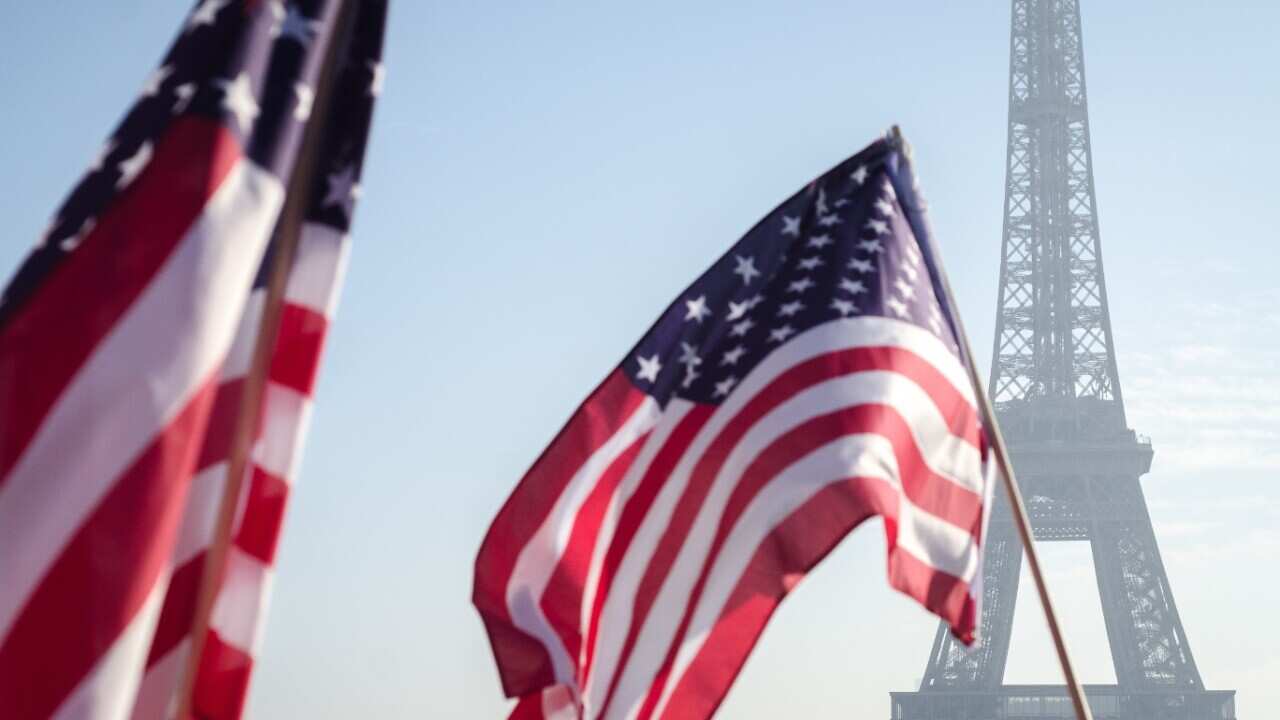 File image of the US flag in front of the Eiffel Tower, 