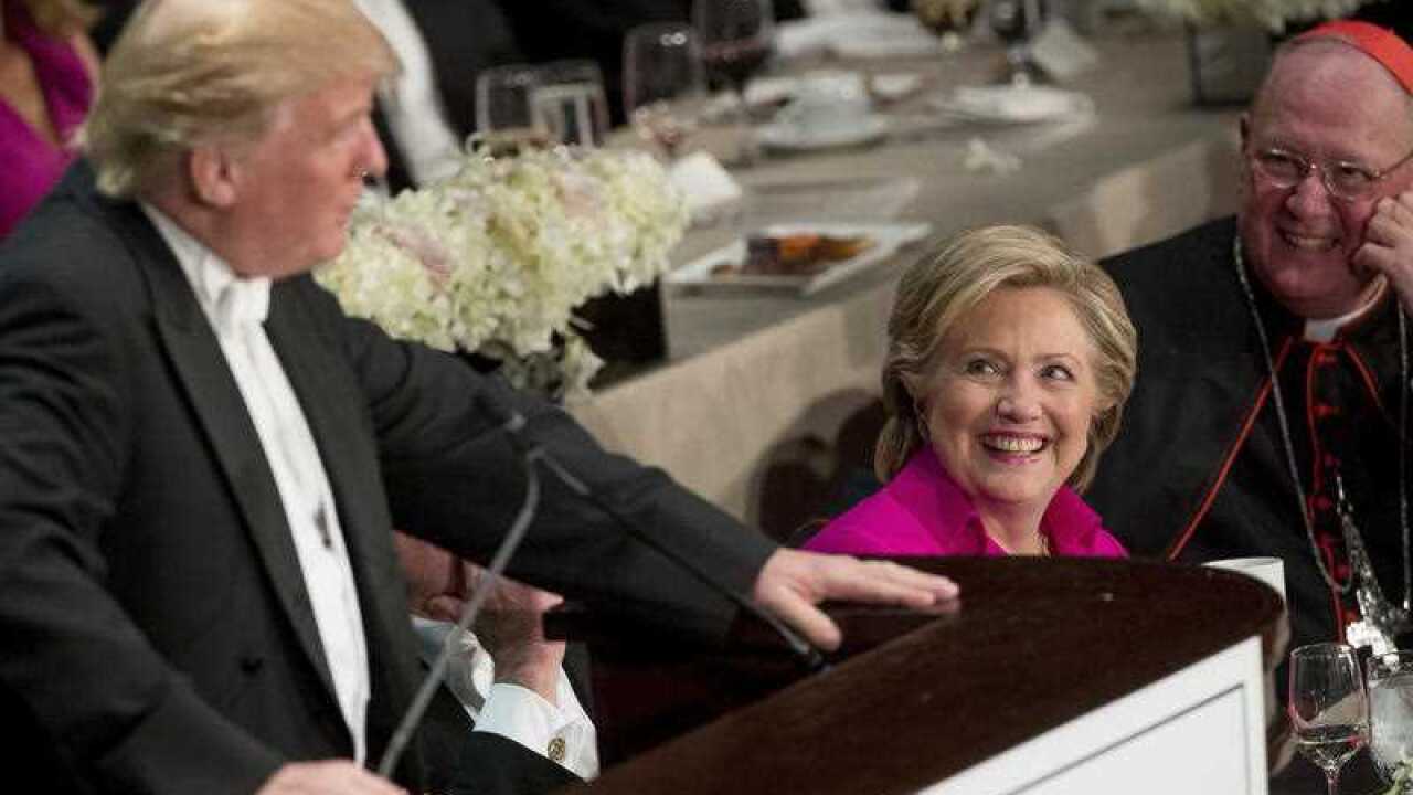 epublican presidential candidate Donald Trump, left, accompanied by Democratic presidential candidate Hillary Clinton, second from right.