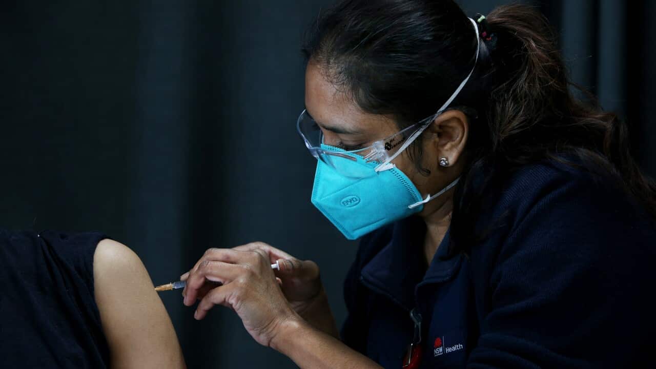 Registered Nurse Shalini administers a Pfizer COVID-19 vaccine to a person visiting the Australian Sikh Association (ASA) pop-up clinic in Sydney.