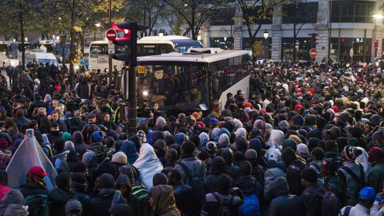 Migrants during the evacuation of a makeshift camp in Paris