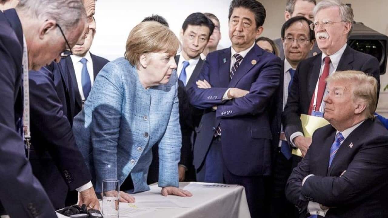 G7 leaders buttonhold President Trump at the G7 summit