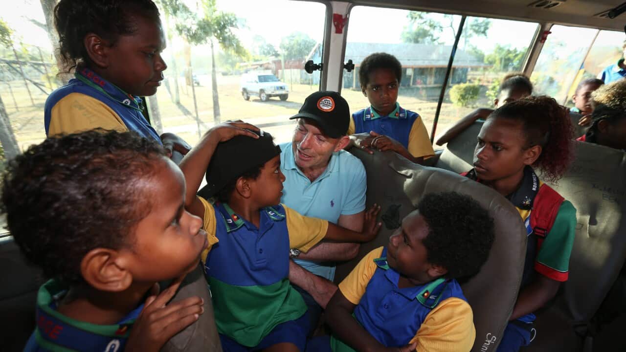 Tony Abbott rides a bus with Bamaga Primary School children during his tour through far north Queensland