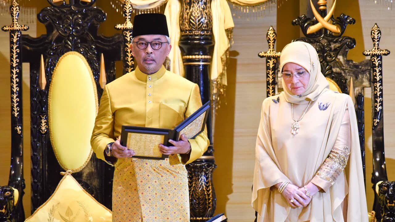 The sixth Sultan of Pahang, Sultan Abdullah ibni Sultan Ahmad Shah, left, takes an oath next to his consort Tunku Azizah Aminah Maimunah Iskandariah.