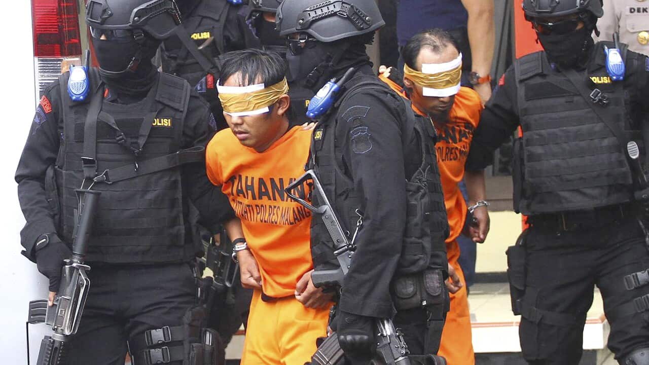 Indonesian police officers escort suspected militants arrested in raids in Malang, East Java, Indonesia (File photo)